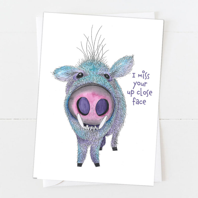 Greeting card featuring a close-up illustration of a javelina's face with a slightly comical, endearing expression. Text reads 'I miss your up close face' in playful lettering.